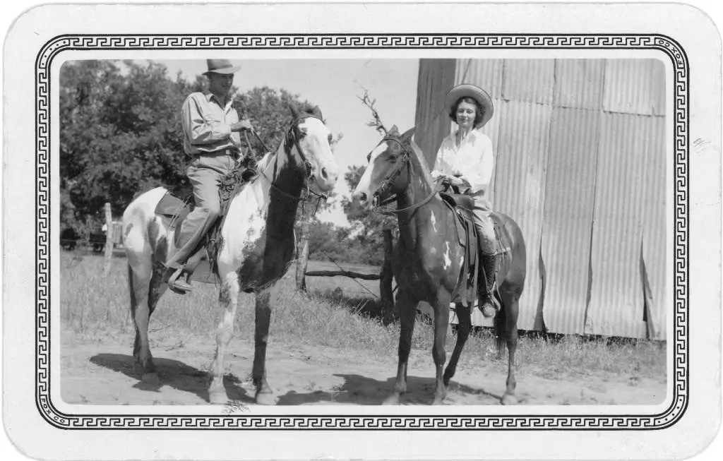 Man and woman riding horses, Texas