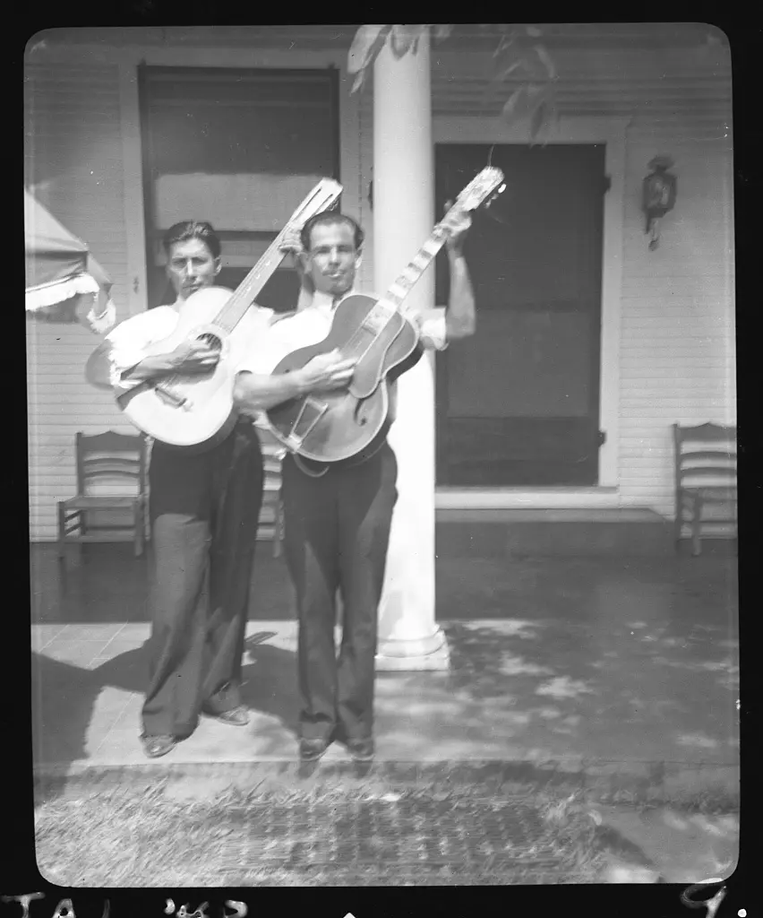 Lolo Mendoza and Chico Real, with guitars, at the home of Mrs. Sarah Kleberg Shelton, Kingsville, Texas